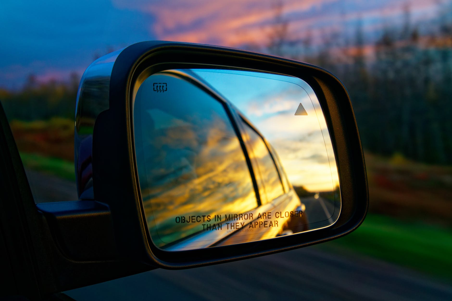 selective focus photography of vehicle side mirror